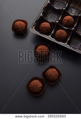 Chocolate Pralines Over Black Background. Top View.
