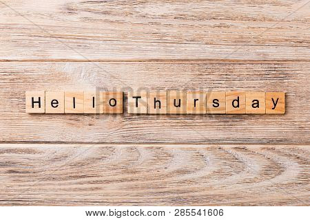 Hello Thursday Word Written On Wood Block. Hello Thursday Text On Wooden Table For Your Desing, Conc