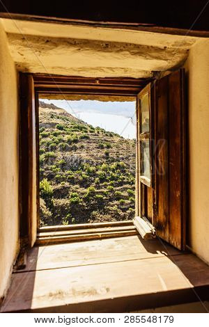 Window Frame Made Of Brown Wood. Old Construction, Ancient Architecture. Enterior Details.