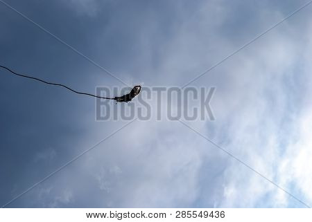 A Female Action Sports Thrill Seeker Jumping From A Bungee Platform.