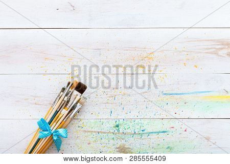 Paint Brushes Set On White Wooden Painted Stained Table With Splashes, Artistic Canvas Background, C