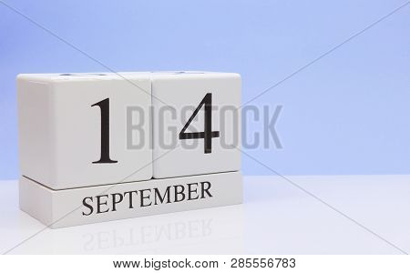 September 14st. Day 14 Of Month, Daily Calendar On White Table With Reflection, With Light Blue Back