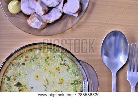 Slicing Homemade Pork Sausage On A Plate And A Plate Of Vegetarian Millet Soup Shot From Above On Th