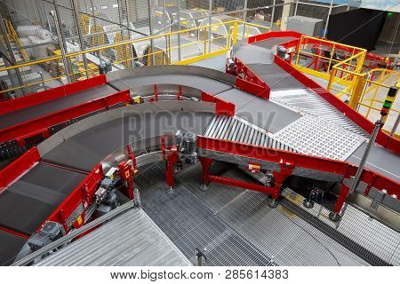 Empty Conveyor Sorting Belt At Distribution Warehouse. Distribution Hub For Sorting Packages And Par