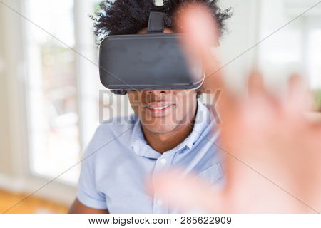 African amaerican man having fun playing with virtual reality glasses