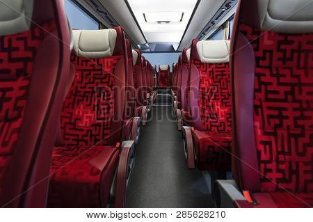 Bus Seats In Row With Red Leather, Textile Coating, Wooden Armrests, White Headrests And Mounts For 