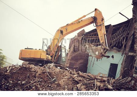excavator crasher machine at demolition on construction site