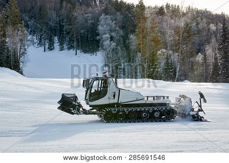 Snowcat On The Mountains And Forest Frosty Winter Day. Snowcat Is Equal To Snow On A Ski Slope In A 