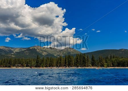Mountains Seen On Shore Across The  Crystal Clear Blue Water, From The Boat On Lake Tahoe In Califor