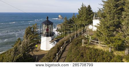 Pacific Ocean Waves Crash Against High Bluffs Below Cape Mears Lighthouse