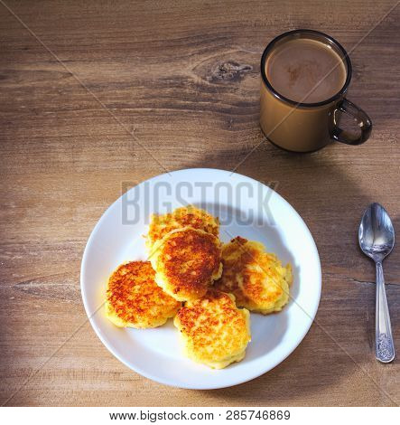 Cottage сheese Pancakes With Fried Crust With With Spun And Coffee On Wooden Background