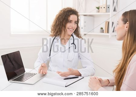 Doctor Using Laptop With Electronic Medical Record System, Reading Patients Health Care And Personal