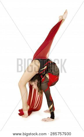 Flexible Equilibrist Performs Exercises On Acrobatic Walking Sticks.