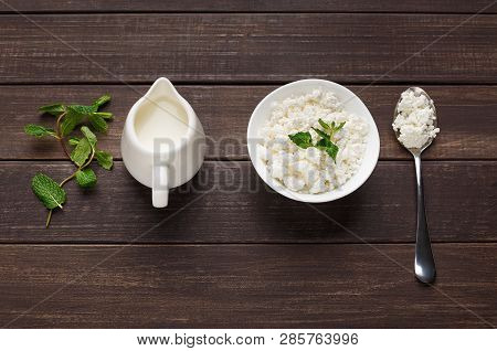 Bowl Of Cottage Cheese And Jar Of Milk On Wooden Background. Lacto Vegetarian Diet Concept