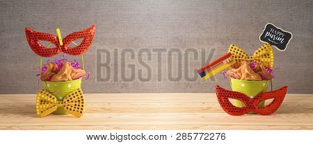 Jewish Holiday Purim Background With Bucket, Carnival Mask, Noisemaker And Hamantaschen Cookies On W