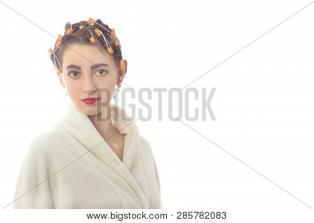 Young Woman With Hair Curlers On Head And Bathrobe Isolated On White Background