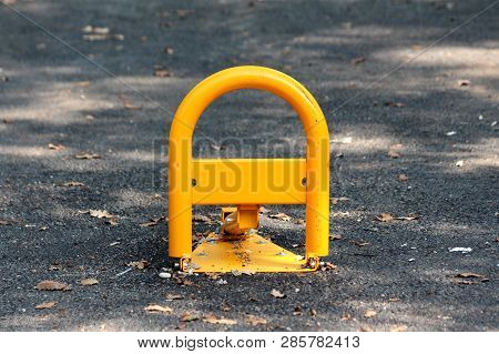 Fold Down Vehicle Security Car Parking Lock Safety Barrier Mounted On Paved Parking Lot Surrounded W