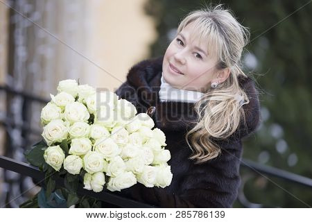 Portrait Of A Woman In A Mink Coat With A Bouquet Of Flowers