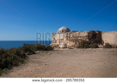 Small Abandoned Mosque / Chapel On The Top Of A Cliff At The Atlantic Ocean Coastline. Dark Blue Wat