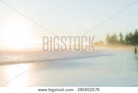 Mount Maunganui New Zealand February 11 2019; Small Unrecognizable Figure Of Woman Walking Away Into