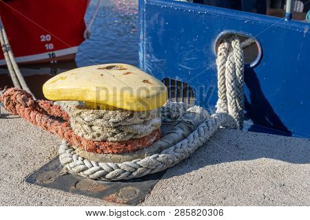 Ship Mooring Rope Moored On The Bollard. Moored Boat In The Port.
