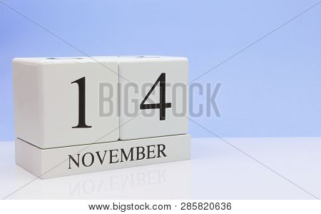 November 14st. Day 14 Of Month, Daily Calendar On White Table With Reflection, With Light Blue Backg