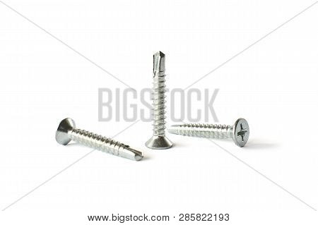 Closeup Self Drilling Screws With A Drill Isolated On White. Isolated Fasteners. Connecting Material