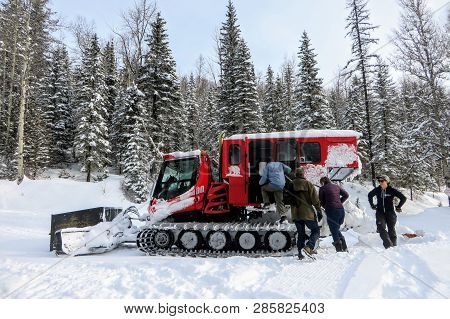 Fernie, British Columbia, Canada - February 23rd, 2019: A Group Of People Boarding A Red Snowcat On 