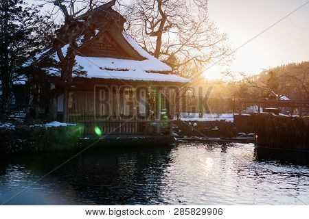 Traditional Japanese Style House At Oshino Hakkai With Mt.fuji With Sunset Flare Light. Landmark Of 