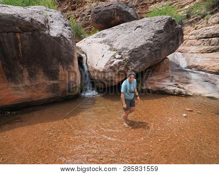Young Woman Enjoys Some Downtime In Hermit Creek During A Multi-day Backpacking Expedition On The He