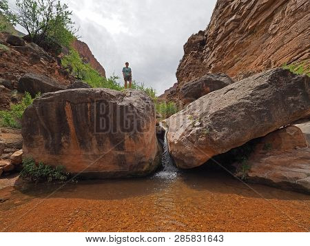 Young Woman Enjoys Some Downtime In Hermit Creek During A Multi-day Backpacking Expedition On The He