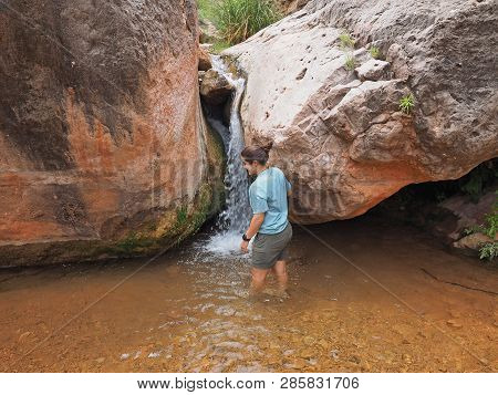 Young Woman Enjoys Some Downtime In Hermit Creek During A Multi-day Backpacking Expedition On The He
