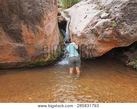 Young Woman Enjoys Some Downtime In Hermit Creek During A Multi-day Backpacking Expedition On The He