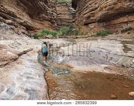 Young Woman Enjoys Some Downtime In Hermit Creek During A Multi-day Backpacking Expedition On The He
