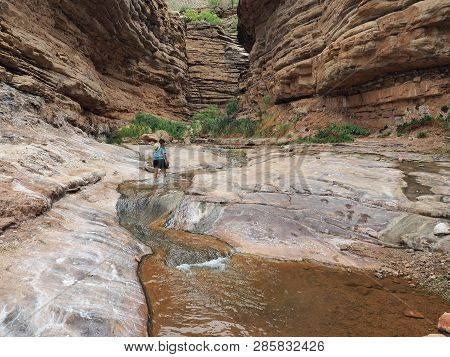 Young Woman Enjoys Some Downtime In Hermit Creek During A Multi-day Backpacking Expedition On The He