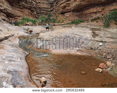 Young Woman Enjoys Some Downtime In Hermit Creek During A Multi-day Backpacking Expedition On The He