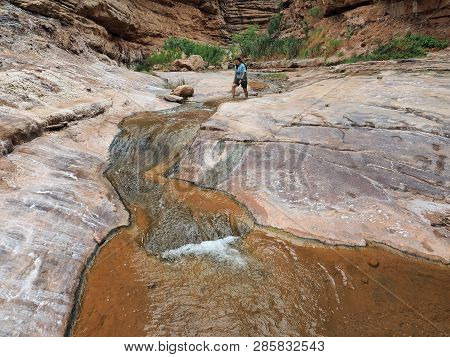 Young Woman Enjoys Some Downtime In Hermit Creek During A Multi-day Backpacking Expedition On The He