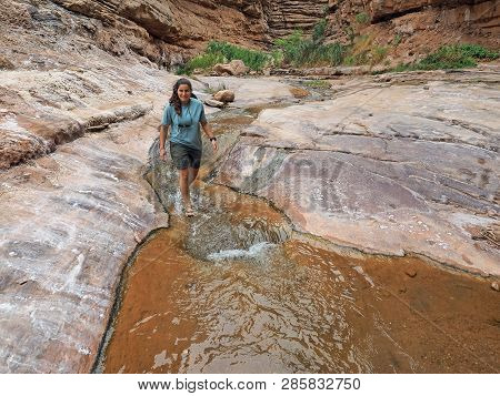 Young Woman Enjoys Some Downtime In Hermit Creek During A Multi-day Backpacking Expedition On The He