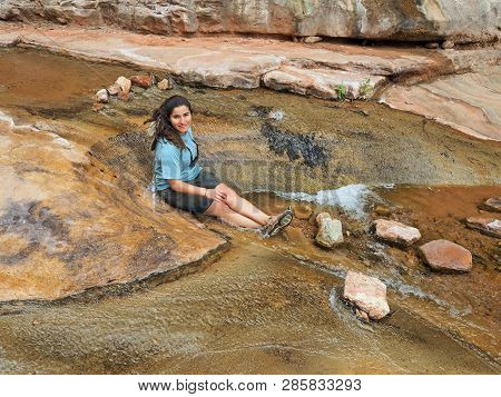 Young Woman Enjoys Some Downtime In Hermit Creek During A Multi-day Backpacking Expedition On The He
