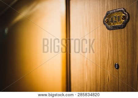 A Hotel Room Door With A Number 421 And A Peephole On It.