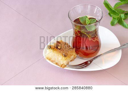 Oriental Dessert Basbousa Or Namoora. Traditional Arabic Dessert And Glass Of Mint Tea. Delicious Ho