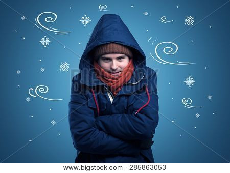 Young hipster frozen boy with doodled snowflakes and windy concept