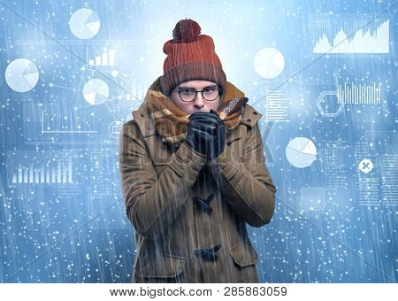 Young businessman shivering with graphs, reports and chart concept