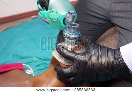 Medical Stuff In Black Gloves Performing Artificial Ventilation Using Bag Valve Mask (ambu Bag) On A