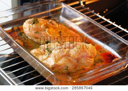 Process Of Cooking Spicy Chicken Fillet In Oven. Chicken Breast Is Fried, Cooking Process. Close Up.