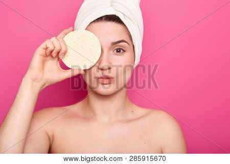 Cropped Image Of Healthy Woman Covers Eye With Bathroom Sponge, Pouts Lips, Has Healty Skin, Wears T