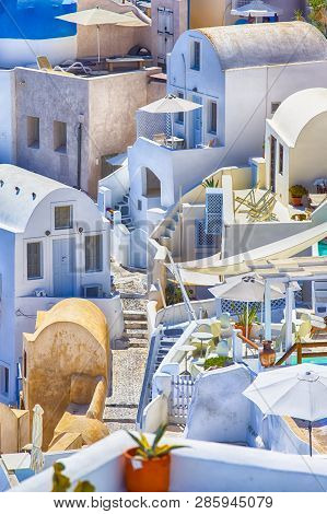 Picturesque Cityscape Of Oia Village In Santorini Island Located On Volcanic Calderra At Daytime. Ve