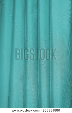 Vertical Folds On Green Organza Curtains For Background And Design