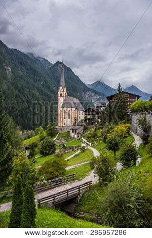 Heiligenblut - a beautiful village in the Alps. Gothic church of St. Vincenzo. The beginning of the road Grossglocknerstrasse. The concept of ecological, historical and phototourism
