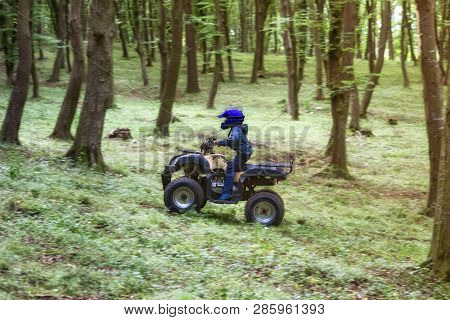 The Boy Is Traveling On An Atv.